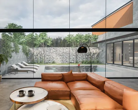 A living room with a cognac leather sofa, a dark stone wall and full-height glass opening onto a pool and a dry-stone garden wall